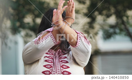 Indian woman celebrating Ganesh Chaturthi with traditional gestures and bangles Indian woman celebrating Ganesh Chaturthi with traditional gestures and bangles 140410850
