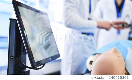 Medical residents training on simulation mannequin with monitor for healthcare education Medical residents training on simulation mannequin with monitor for healthcare education 140410861