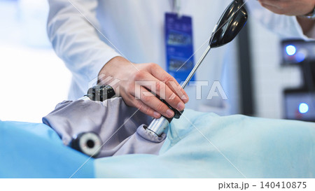 Surgeon performing laparoscopic surgery using advanced medical equipment in operating room Surgeon performing laparoscopic surgery using advanced medical equipment in operating room 140410875