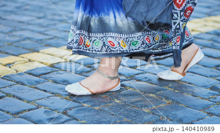Bangladeshi woman wearing traditional saree and anklet walking on cobblestones in Moscow Bangladeshi woman wearing traditional saree and anklet walking on cobblestones in Moscow 140410989