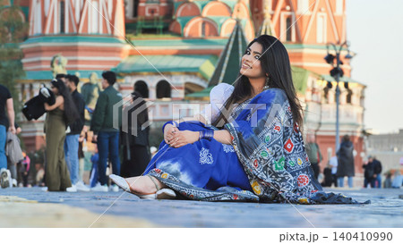 Bangladeshi woman sitting on Red Square in Moscow, smiling and enjoying travel experience Bangladeshi woman sitting on Red Square in Moscow, smiling and enjoying travel experience 140410990