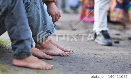 Barefoot devotees waiting for Ganesha festival celebration and procession in India Barefoot devotees waiting for Ganesha festival celebration and procession in India 140411085