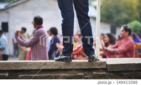 Person observing a Hindu Ganesh Chaturthi community celebration with people dancing Person observing a Hindu Ganesh Chaturthi community celebration with people dancing 140411098