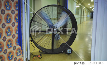 Giant industrial fan ventilating a long hallway during Ganesha festival in India Giant industrial fan ventilating a long hallway during Ganesha festival in India 140411099