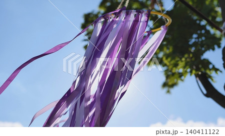 Purple ribbons fluttering in wind at India Day event in Moscow park under blue sky 140411122