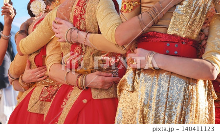 Women dressed in traditional Indian attire embracing at a cultural festival in Moscow Women dressed in traditional Indian attire embracing at a cultural festival in Moscow 140411123