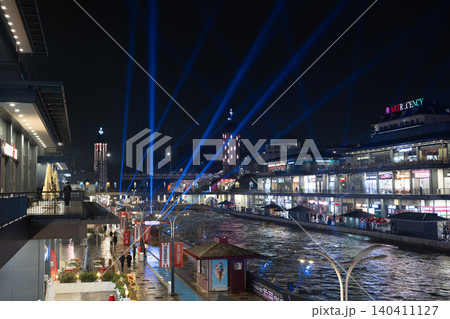 Tashkent, Uzbekistan - February 02, 2026: Seoul Mun Street. Blue and green Light Show at Seoul Mun Riverside District in Tashkent at Night. Tashkent, Uzbekistan - February 02, 2026: Seoul Mun Street. Blue and green Light Show at Seoul Mun Riverside District in Tashkent at Night. 140411127