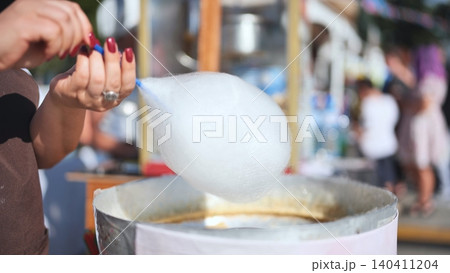Making fresh cotton candy at a street festival during India Day in Moscow 140411204