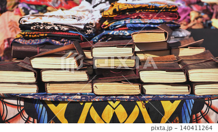 Leather religious Indian books on a street shop table in India. 140411264