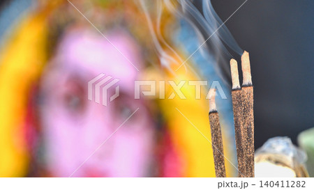 Burning incense sticks releasing smoke with a deity image during India Day festival in Moscow 140411282
