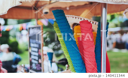 Stacks of vibrant ice cream cones ready for serving at a street food stall 140411344