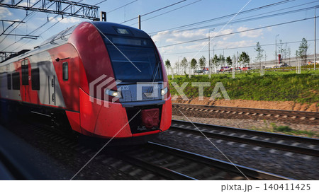 Lastochka train travelling fast on tracks in Moscow, modern transport system Lastochka train travelling fast on tracks in Moscow, modern transport system 140411425