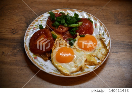 Fried eggs for delicious healthy easy breakfast on a table. Fresh homemade meal on a frying pan. Traditional breakfast food. International cuisine food. Fried eggs for delicious healthy easy breakfast on a table. Fresh homemade meal on a frying pan. Traditional breakfast food. International cuisine food. 140411458