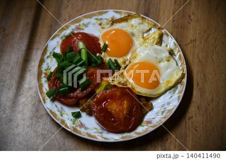 Fried eggs for delicious healthy easy breakfast on a table. Fresh homemade meal on a frying pan. Traditional breakfast food. International cuisine food. Fried eggs for delicious healthy easy breakfast on a table. Fresh homemade meal on a frying pan. Traditional breakfast food. International cuisine food. 140411490