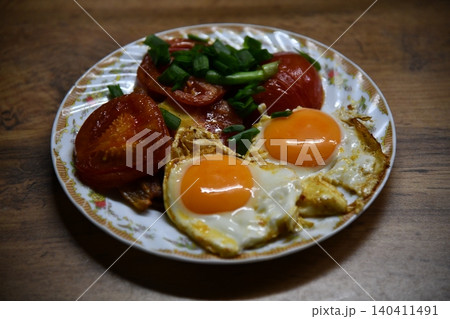 Fried eggs for delicious healthy easy breakfast on a table. Fresh homemade meal on a frying pan. Traditional breakfast food. International cuisine food. Fried eggs for delicious healthy easy breakfast on a table. Fresh homemade meal on a frying pan. Traditional breakfast food. International cuisine food. 140411491
