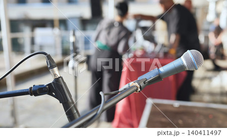 Microphone on stage ready for live music performance or outdoor public event 140411497