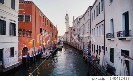 Venice canal view with leaning bell tower at peaceful evening. San Giorgio dei Greci church 140412438