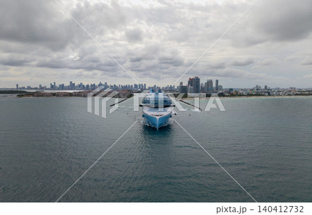 Aerial view cruise ship on summer vacation tour. Cruise ship vacation and travel by sea. Aerial view luxury liner. Ship leaving Miami beach port. Cruise ship vacation. Sail the sea Aerial view cruise ship on summer vacation tour. Cruise ship vacation and travel by sea. Aerial view luxury liner. Ship leaving Miami beach port. Cruise ship vacation. Sail the sea 140412732