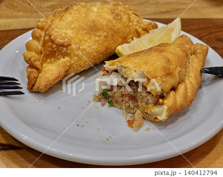 Traditional Argentine empanadas with beef, cheese and vegetable fillings Traditional Argentine empanadas with beef, cheese and vegetable fillings 140412794