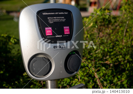 electric vehicle charging station in green public park 140413010