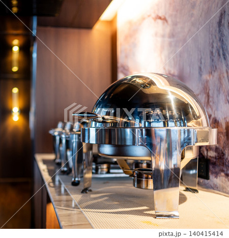 Closed round chafing dish or buffet warmer in dining area of luxury hotel Closed round chafing dish or buffet warmer in dining area of luxury hotel 140415414