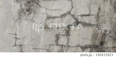 The texture of the old concrete wall is gray with an irregular crack pattern. 140415923