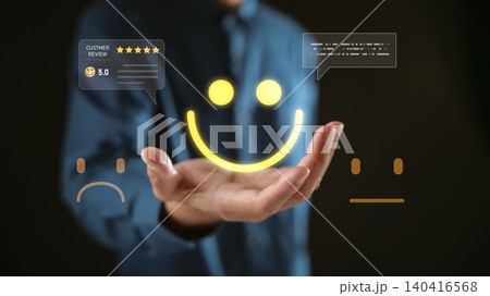 Satisfaction from smile customer review and positive feedback user experience builds online business reputation as glowing icon for five star rating appears over hand in darkness Satisfaction from smile customer review and positive feedback user experience builds online business reputation as glowing icon for five star rating appears over hand in darkness 140416568