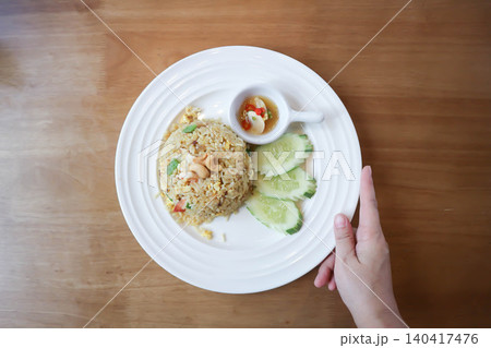 stir fried rice or fried rice  with cashew nut topping and cucumber 140417476