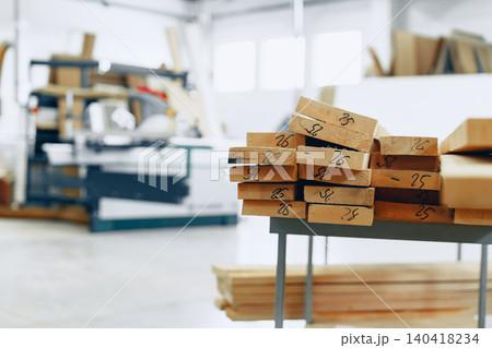 Workspace shows wooden pieces and tools in a furniture workshop for crafting and building items Workspace shows wooden pieces and tools in a furniture workshop for crafting and building items 140418234