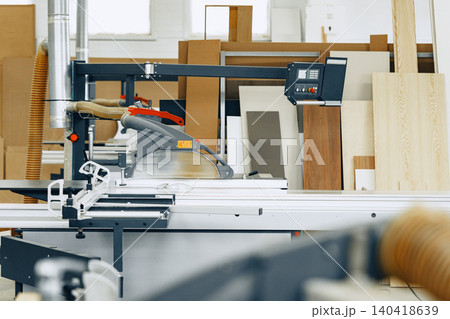 Furniture workshop shows wood cutting machinery ready for use during work hours 140418639