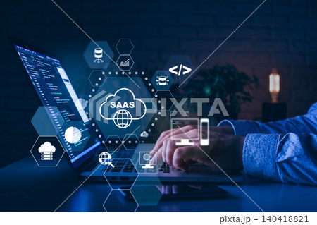 Working on software as a service application with laptop in dark environment at night Working on software as a service application with laptop in dark environment at night 140418821