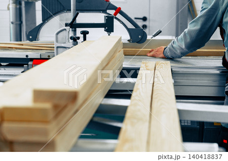 Crafting wooden pieces in a furniture workshop during day hours 140418837