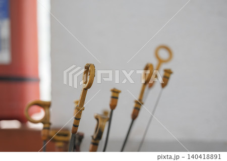 Shallow depth of field shot of several yellow plastic dipstick handles for checking car oil Shallow depth of field shot of several yellow plastic dipstick handles for checking car oil 140418891