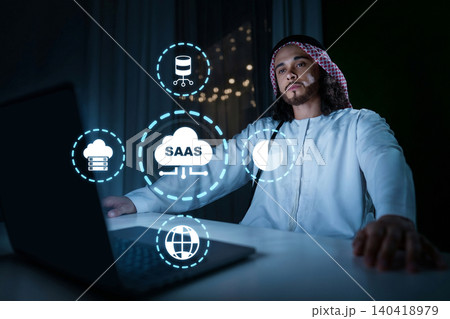 Man works on a laptop while exploring SaaS concepts in a modern workspace Man works on a laptop while exploring SaaS concepts in a modern workspace 140418979