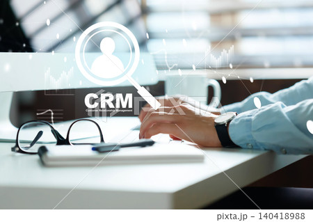 Using CRM software on computer for customer management in a modern office setting 140418988