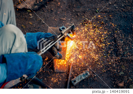 Cutting steel with gas, gas welding and oxy-fuel cutting are processes that use fuel gases and oxygen to weld and cut metals, respectively. industrial worker cutting thick steel in workshop. 140419091
