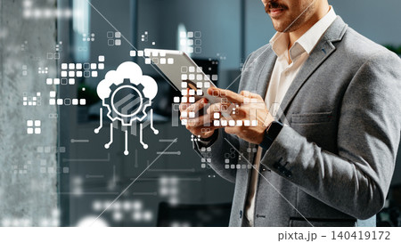 Business professional using tablet in office to monitor software and data systems 140419172