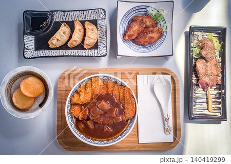 Delicious Japanese meal assortment with katsu curry, gyoza, and skewers Delicious Japanese meal assortment with katsu curry, gyoza, and skewers 140419299