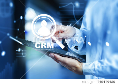 Using CRM software on a tablet to manage customer information in a business setting Using CRM software on a tablet to manage customer information in a business setting 140419480