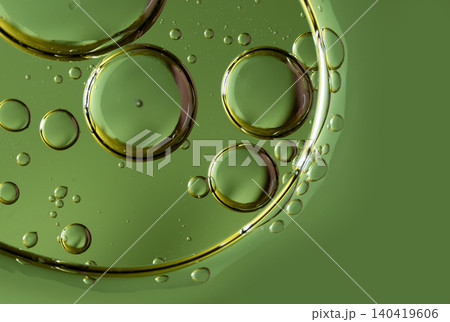 Overlapping oil spheres on a vivid green background suggesting organic cell structures Overlapping oil spheres on a vivid green background suggesting organic cell structures 140419606