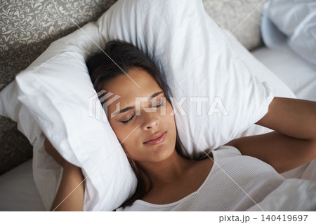 Woman, pillow and frown for noise, stress or tired for insomnia or nightmare in bedroom in Las Vegas. Mental health, female person and angry for sleepless, fatigue and loud sound in hotel room Woman, pillow and frown for noise, stress or tired for insomnia or nightmare in bedroom in Las Vegas. Mental health, female person and angry for sleepless, fatigue and loud sound in hotel room 140419697