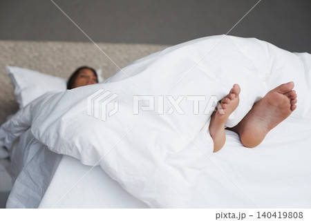 Tired, feet and woman in bed sleeping, home and white duvet for bedding , lazy and exhausted. Morning, bedroom and female person on day off to relax in apartment, rest and cosy with blanket and dream Tired, feet and woman in bed sleeping, home and white duvet for bedding , lazy and exhausted. Morning, bedroom and female person on day off to relax in apartment, rest and cosy with blanket and dream 140419808