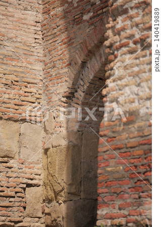 Textured old red brickwork and stone foundation of a historic fortress or church wall Textured old red brickwork and stone foundation of a historic fortress or church wall 140419889