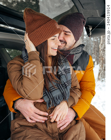 enjoys time together in snow covered forest during winter afternoon 140419914
