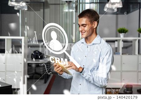 Business professional using CRM tools in modern office environment in the afternoon Business professional using CRM tools in modern office environment in the afternoon 140420179