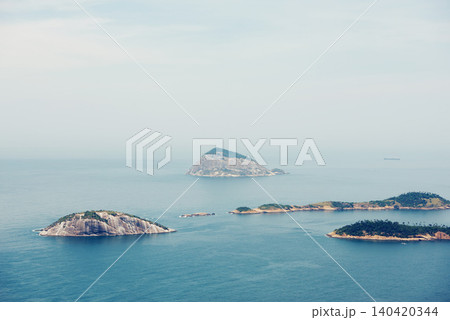 Ocean, nature and aerial of island in sea for travel, holiday and vacation destination in summer. Natural background, seascape and islands in water for scenic view in environment, ecosystem and waves 140420344