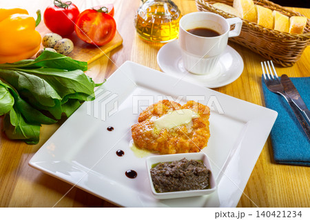 Delicious breakfast meal with eggs, bread, and fresh vegetables on a wooden table 140421234
