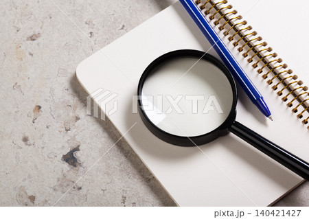 Tools for studying and examining notes on a flat surface with a notebook and pen present Tools for studying and examining notes on a flat surface with a notebook and pen present 140421427