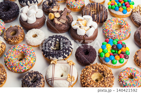 Delicious assortment of donuts with various toppings in a bright setting 140421592