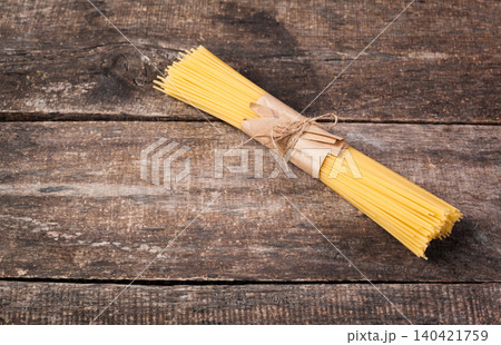 Spaghetti tied with string on wooden table ready for cooking 140421759